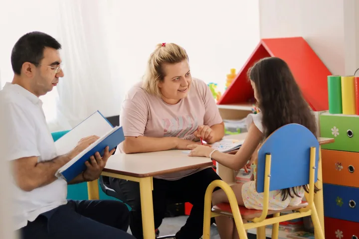 Speech pathologist facilitating a language and communication therapy session